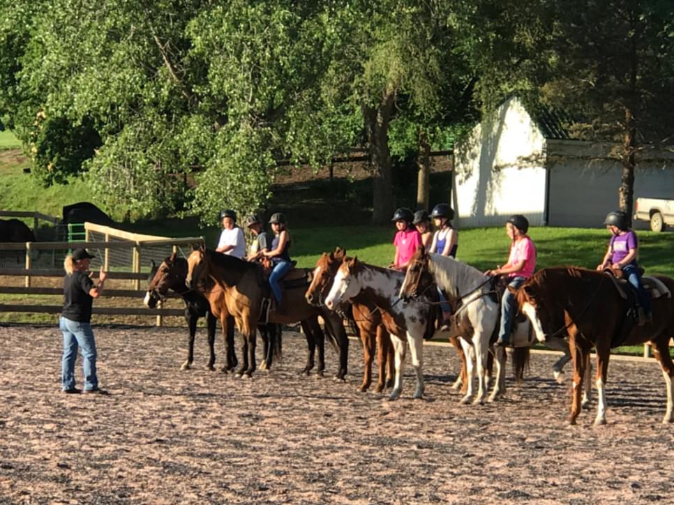 Riders at a western pleasure horse riding lesson.